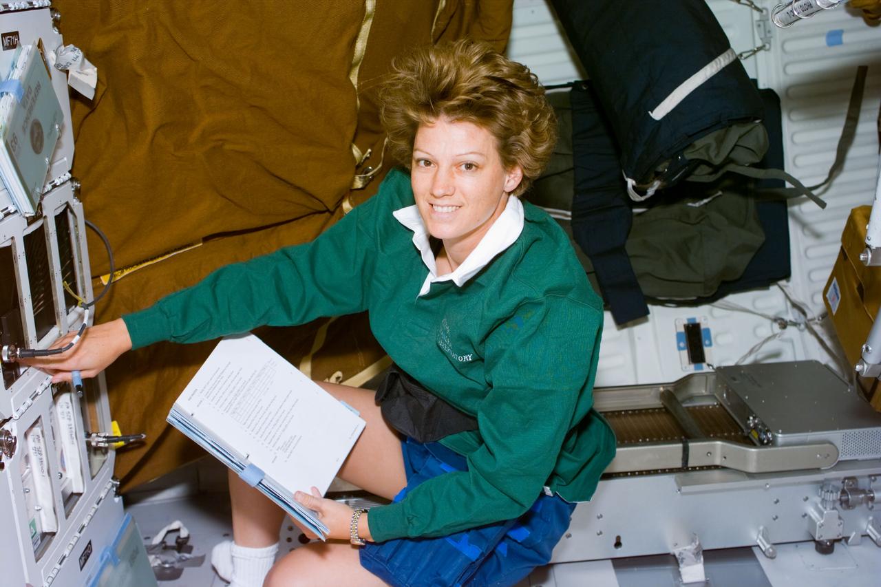 S93-E-5016 (23 July 1999) --- Astronaut Eileen M. Collins, mission commander,  checks on an experiment on Columbia's  middeck during Flight Day 1 activity.  The experiment is called the Cell Culture Model, Configuration C.  Objectives of it are to validate cell culture models for muscle, bone and endothelial cell biochemical and functional loss induced by microgravity stress; to evaluate cytoskeleton, metabolism, membrane integrity and protease activity in target cells; and to test tissue loss pharmaceuticals for efficacy. The photo was recorded with an electronic still camera (ESC).