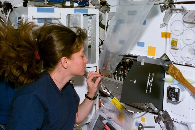 NASA image: PGIM-01, Coleman at middeck locker with rigged plastic air duct