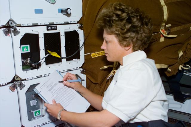 NASA image: CCM-C,Collins checks the middeck experiment
