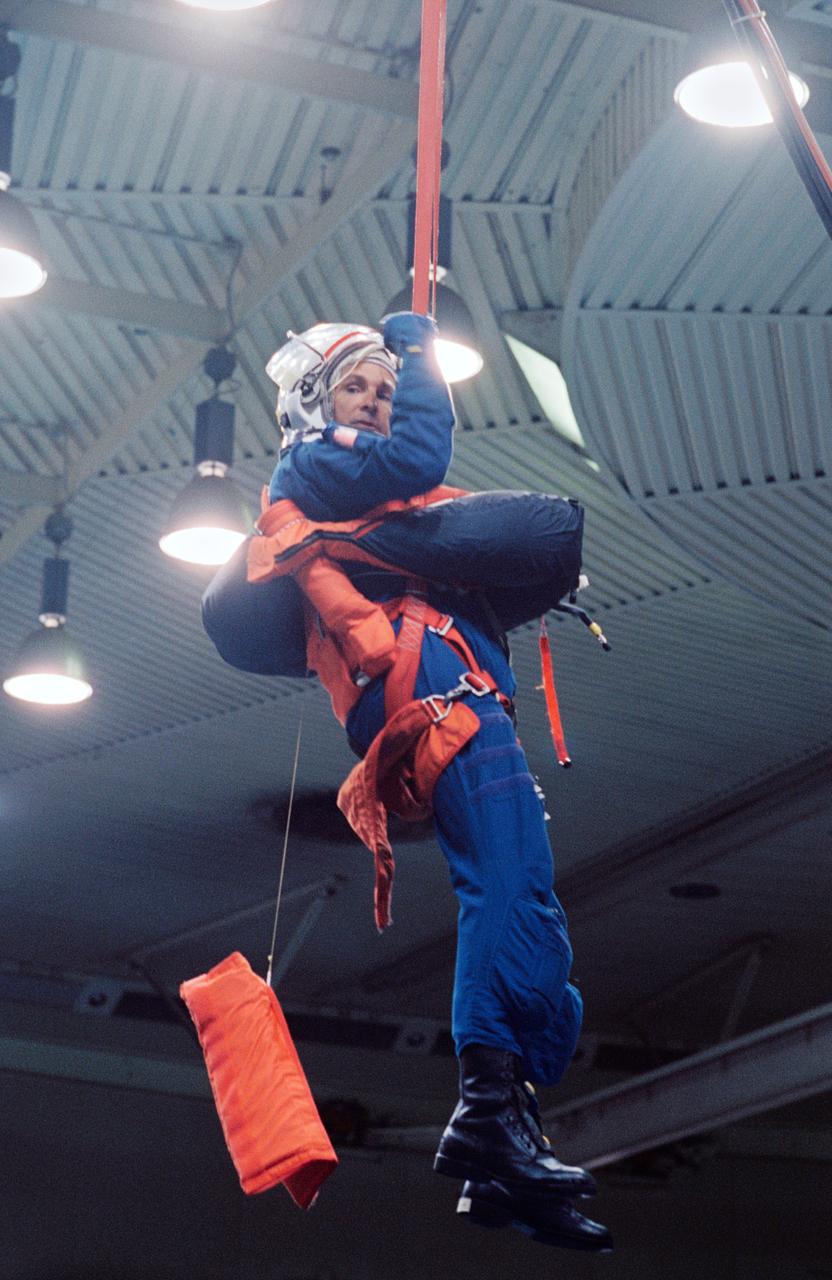 S94-37516 (28 June 1994) --- Astronaut Curtis L. Brown is suspended by a simulated parachute gear during an emergency bailout training exercise in the Johnson Space Center's (JSC) Weightless Environment Training Facility (WET-F).  Making his second flight in space, Brown will join four other NASA astronauts and a European mission specialist for a week and a half in space aboard the Space Shuttle Atlantis in support of the Atmospheric Laboratory for Applications and Science (ATLAS-3) mission.