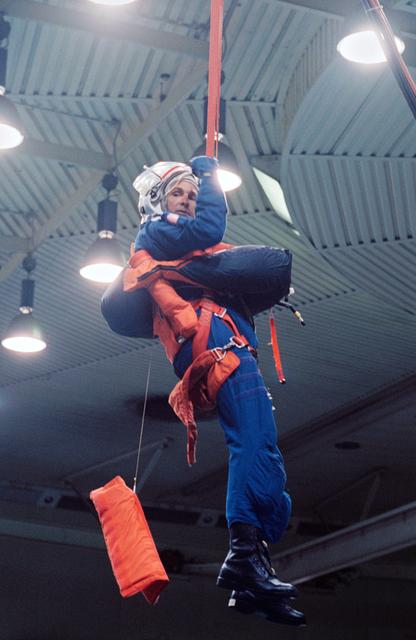 NASA image: Astronaut Curtis Brown suspended by simulated parachute gear during training