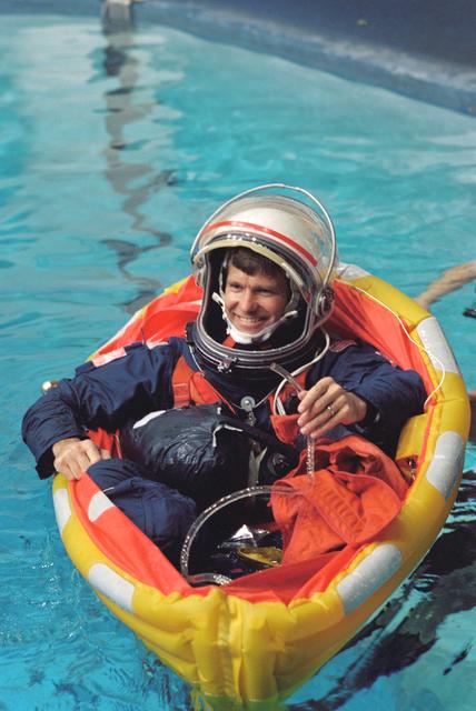 NASA image: Astronaut Donald McMonagle checks drainage hose on his life raft in training