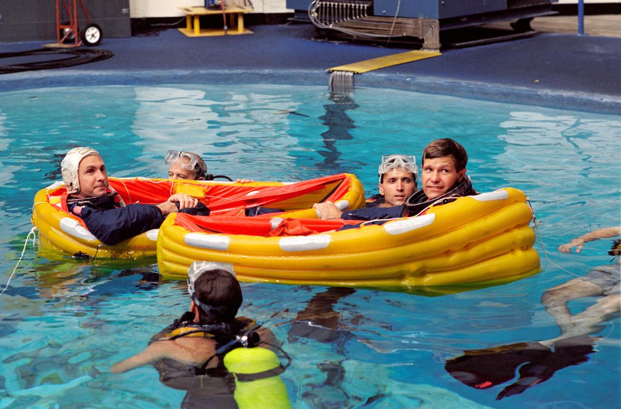 S94-37526 (28 June 1994) --- In separate life rafts, astronauts Donald R. McMonagle (right), mission commander, and Curtis L. Brown, pilot, are assisted by several SCUBA-equipped divers during an emergency bailout training exercise in the Johnson Space Center's (JSC) Weightless Environment Training Facility (WET-F). Making their third and second flights in space, respectively, McMonagle and Brown will be joined by three other NASA astronauts and a European mission specialist for a week and a half in space aboard the Space Shuttle Atlantis. The flight will support the Atmospheric Laboratory for Applications and Science (ATLAS-3) mission.