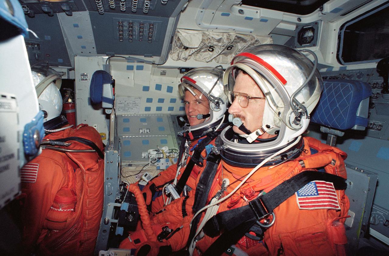 S94-40083 (23 June 1994) --- Astronaut Scott E. Parazynski looks at fellow STS-66 mission specialist Joseph R. Tanner, (foreground) during a rehearsal of procedures to be followed during launch and entry phases of the their scheduled November flight.  This rehearsal, held in the Crew Compartment Trainer (CCT) of the Johnson Space Center's (JSC) Shuttle Mockup and Integration Laboratory, was followed by a training session on emergency egress procedures.  In November, Parazynski and Tanner will join three other NASA astronauts and a European mission specialist for a week and a half aboard the Space Shuttle Atlantis in Earth-orbit in support of the Atmospheric Laboratory for Applications and Science (ATLAS-3).