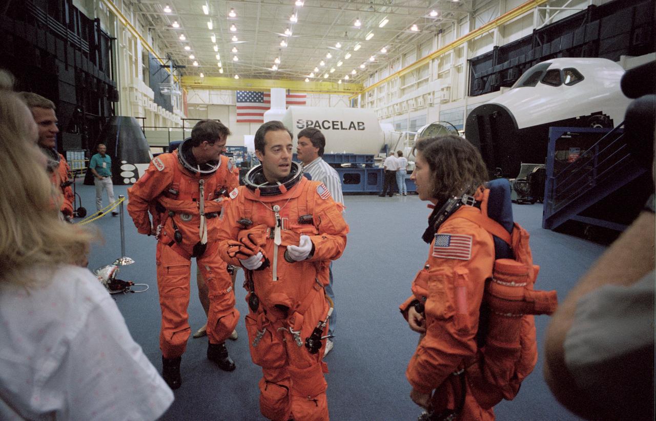 S94-40095 (23 June 1994) --- Jean-Francois Clervoy (center), STS-66 international mission specialist, chats with payload crew mates during a training session on emergency egress procedures. Wearing training versions of the launch and entry suits (LES), the crew members are, left to right, Scott E. Parazynski, Joseph P. Tanner, Clervoy and Ellen Ochoa. Ochoa is payload commander; Tanner and Parazynski are NASA mission specialists and Clervoy represents the European Space Agency (ESA) as a mission specialist. Six astronauts will spend a week and a half aboard the Space Shuttle Atlantis in Earth-orbit in support of the Atmospheric Laboratory for Applications and Science (ATLAS-3).