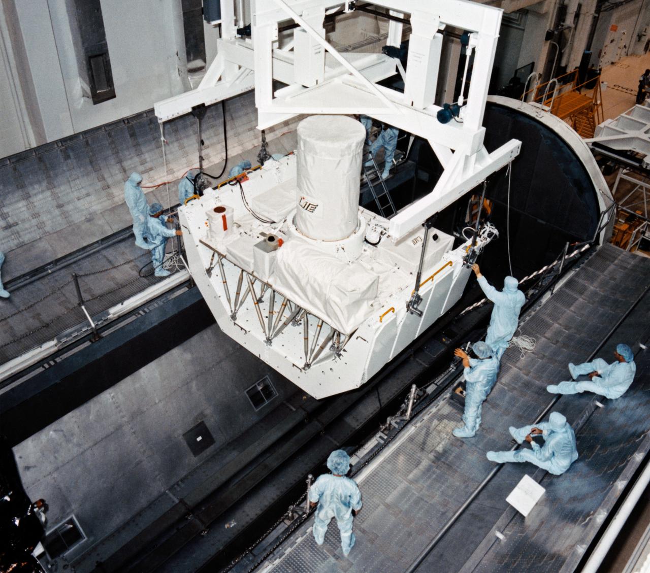 S94-40916 (5 July 1994) --- Workers in the Operations and Checkout Building are transporting the Lidar In-Space Technology Experiment (LITE-1) into the payload canister transporter for transfer to the Orbiter Processing Facility, where it will be installed into the cargo bay of the space shuttle Discovery. LITE-1, which will demonstrate the technology of a spaceborne Lidar instrument, is scheduled to fly on STS-64 later this year. Photo credit: NASA or National Aeronautics and Space Administration