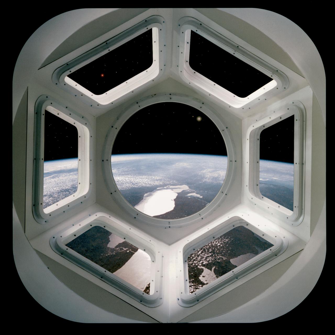 S94-47164 (December 1994) --- A computer generated scene gives the perspective of a crew member looking through the Cupola on the International Space Station (ISS). Several of the Great Lakes help to form the backdrop for the scene.