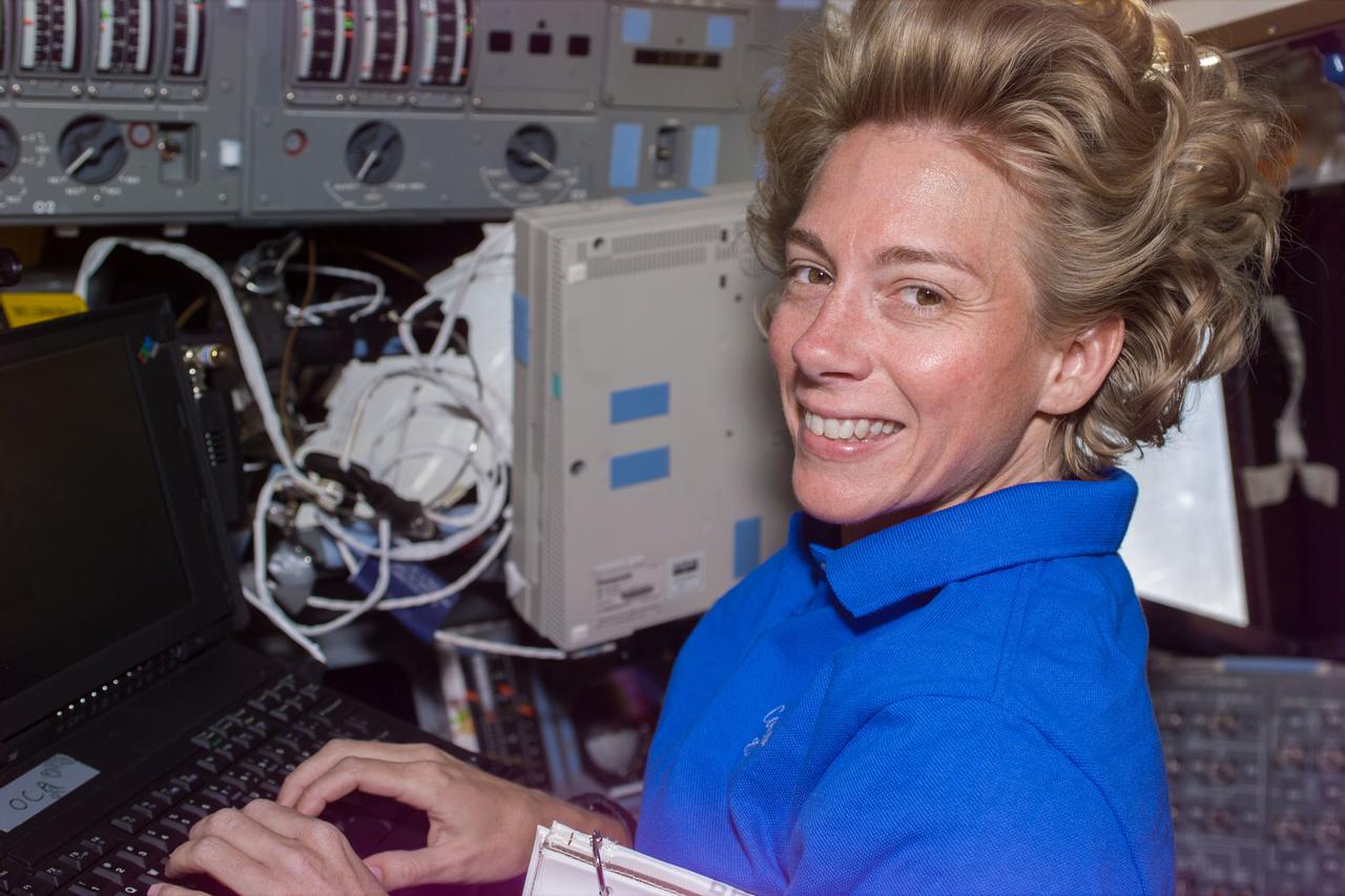 S94-E-5004 (5 July 1997) --- Astronaut Susan L. Still, at the pilot's station on the Space Shuttle Columbia's forward flight deck, works at a lap top computer.