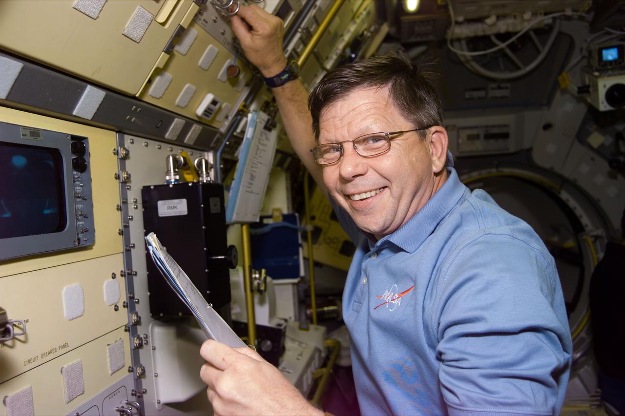 S94-E-5019 (6 July 1997) --- Roger K. Crouch, payload specialist for the Microgravity Sciences Laboratory (MSL-1) mission, is seen at the experiment racks during Flight Day 6 aboard Spacelab.  The photo was recorded with an Electronic Still Camera (ESC) and later downlinked to ground controllers in Houston, Texas.