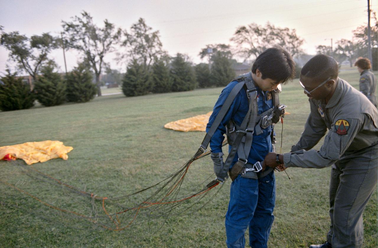 S95-00352 (12-14 September 1992) --- Astronaut candidate Koichi Wakata gets assistance with his parachute following a simulated chute drop at Vance Air Force Base. Wakata, representing the National Space Development Agency (NASDA) of Japan, is one of seven international mission specialist candidates who joined 19 United States astronaut candidates for the three-day parachute/survival training school at the Oklahoma Base. EDITOR'S NOTE: Since this photograph was taken, Wakata has been named as mission specialist for the STS-72 mission.