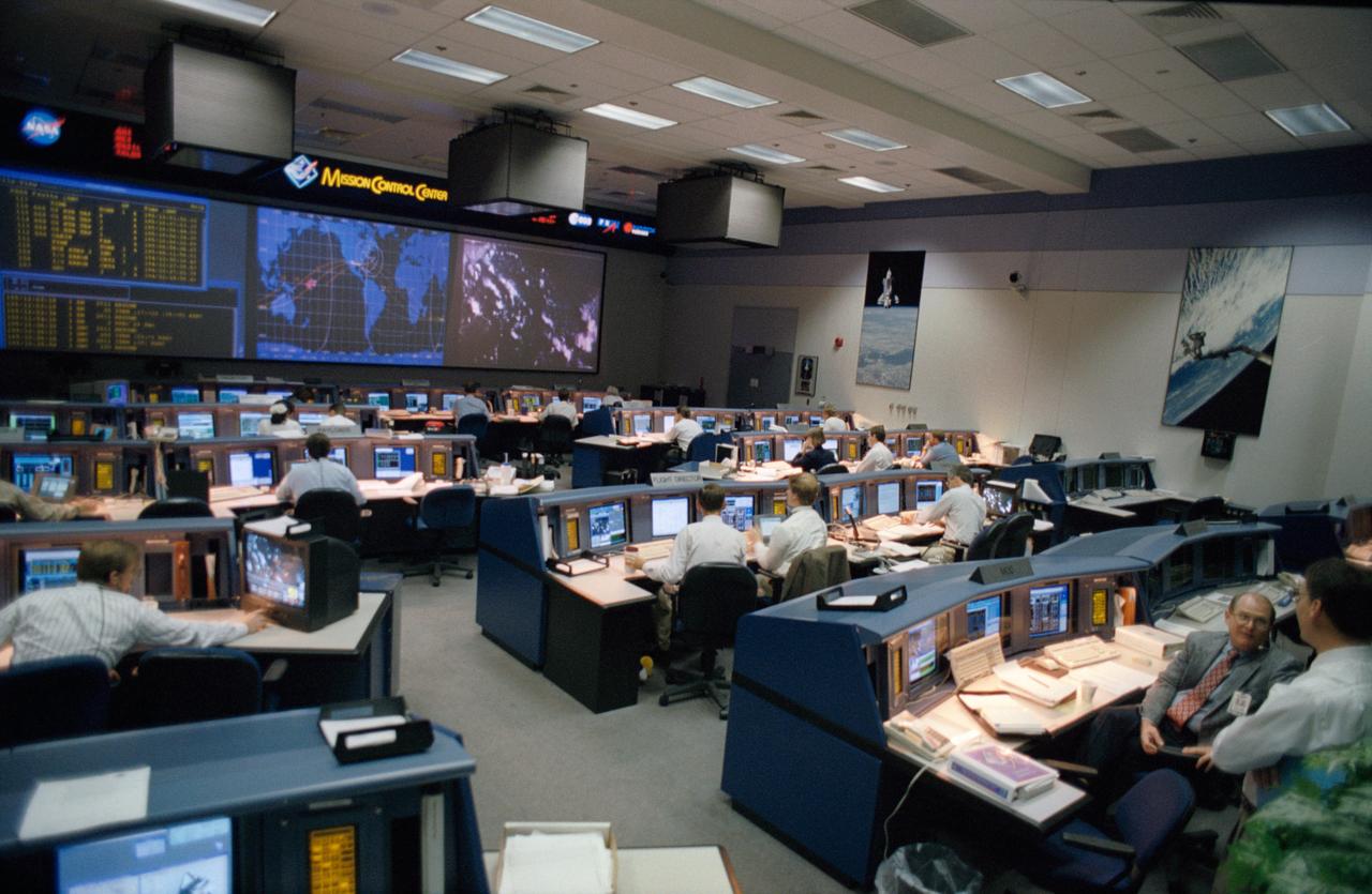 S95-16439 (13-22 July 1995) --- An overall view from the rear shows activity in the new Mission Control Center (MCC), opened for operation and dedicated during the STS-70 mission.  The new MCC, developed at a cost of about 50 million, replaces the main-frame based, NASA-unique design of the old Mission Control with a standard workstation-based, local area network system commonly in use today.