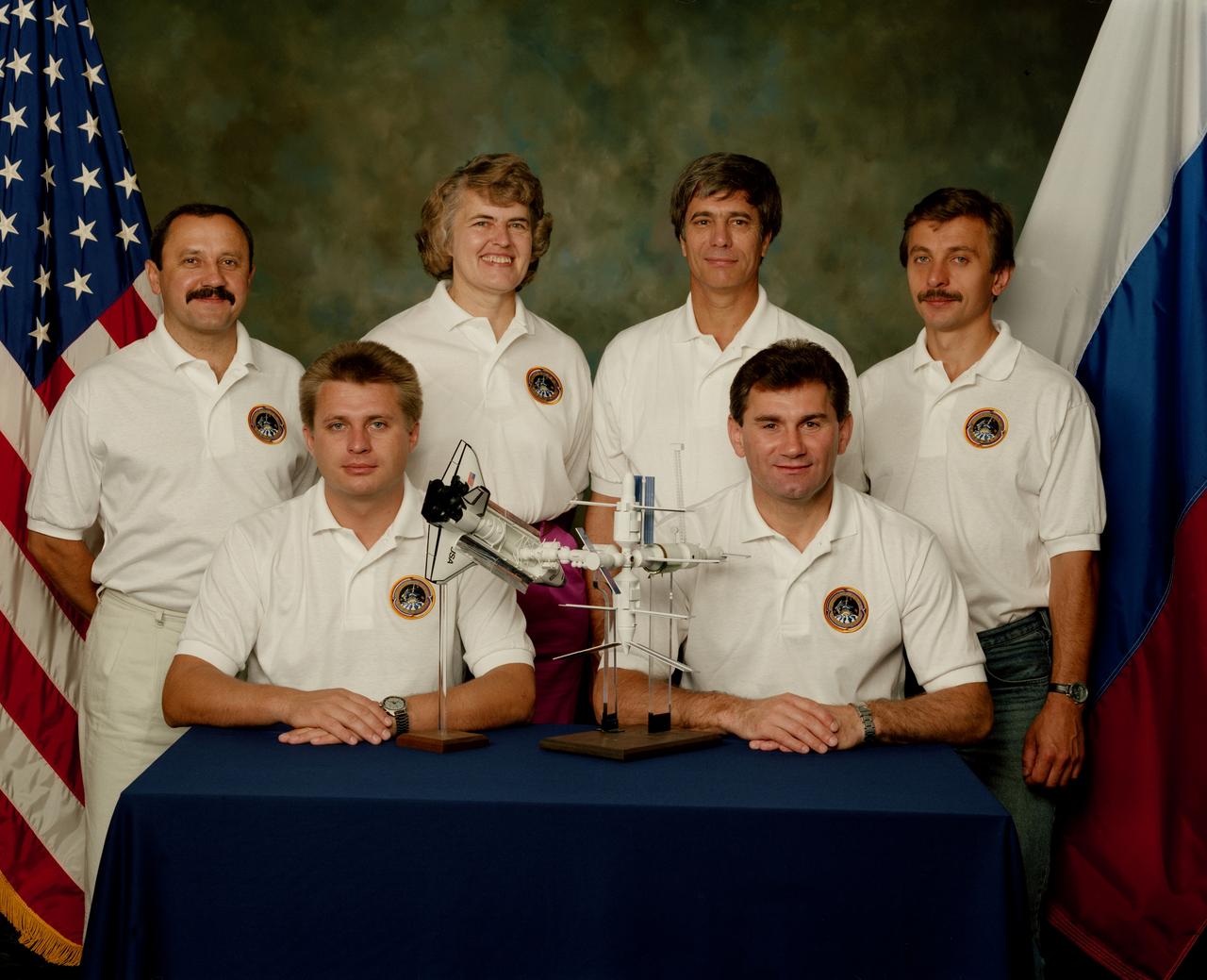 S95-16674 (14 July 1995) --- On the left is the Mir-21 crew consisting of cosmonaut Yuriy V. Usachov (standing), flight engineer; Yuriy I. Onufriyenko (seated), commander; and Shannon W. Lucid, cosmonaut guest researcher. On the right side is the Mir-23 crew consisting of John E. Blaha (standing), cosmonaut guest researcher; Vasili V. Tsibliyev (seated), commander; and Aleksandr I. Lazutkin, flight engineer.  NASA astronauts Lucid and Blaha each will go into space to board Russia's Mir Space Station for lengthy research on their respective missions.  Lucid will board the Mir during the STS-76 mission.  Blaha will replace Lucid onboard the Mir during the STS-79 mission.