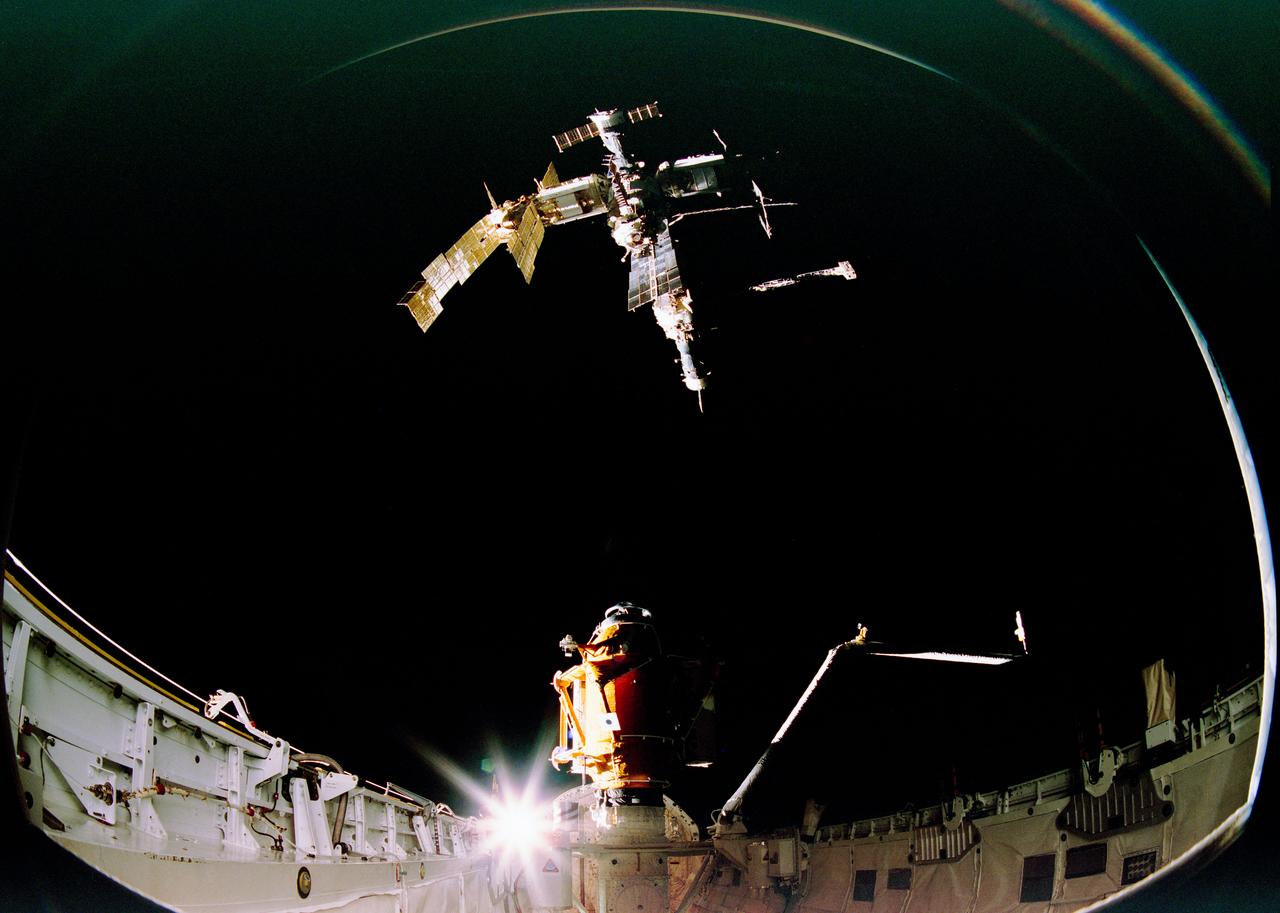 S95-22092 (15 Nov 1995) --- The Space Shuttle Atlantis moves within 80 feet of Russia's Mir Space Station during rendezvous and docking operations.  During the STS-74 mission, the crew used an IMAX camera to document the Space Shuttle Atlantis' rendezvous and docking with the Mir Space Station.  The 65mm camera system was located in the Atlantis' cargo bay and provided a unique fish-eye perspective.  These images were selected from footage that will be incorporated in a large-format feature film about NASA's cooperative program with the Russians.  NASA has flown IMAX camera systems on many Shuttle missions, including the recent STS-63 Shuttle-Mir rendezvous and STS-71 Shuttle-Mir docking.  Film from previous missions was used to create the productions The Dream is Alive, The Blue Planet, and Destiny in Space.