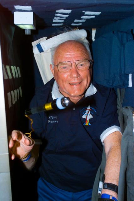 NASA image: Glenn in his sleep rack on the Discovery's middeck
