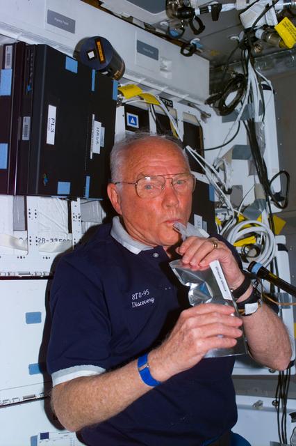 NASA image: Glenn on middeck with drink package
