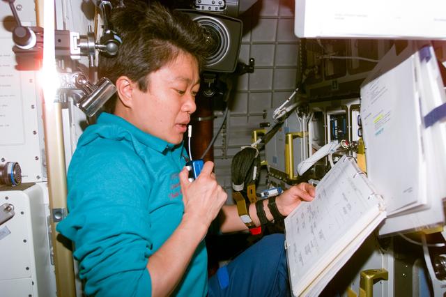 NASA image: Mukai reviews checklist in the Spacehab module