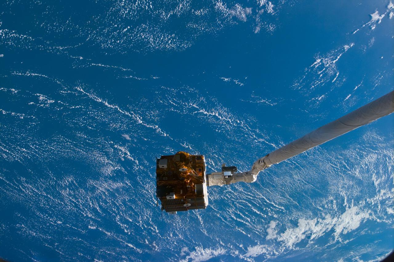 STS095-E-5084 (1 Nov. 1998) --- The Spartan 201-05 is in the grasp of Discovery's remote manipulator system (RMS) prior to release. The photo was taken with an electronic still camera (ESC) at 1:45:40 GMT, Nov. 1.