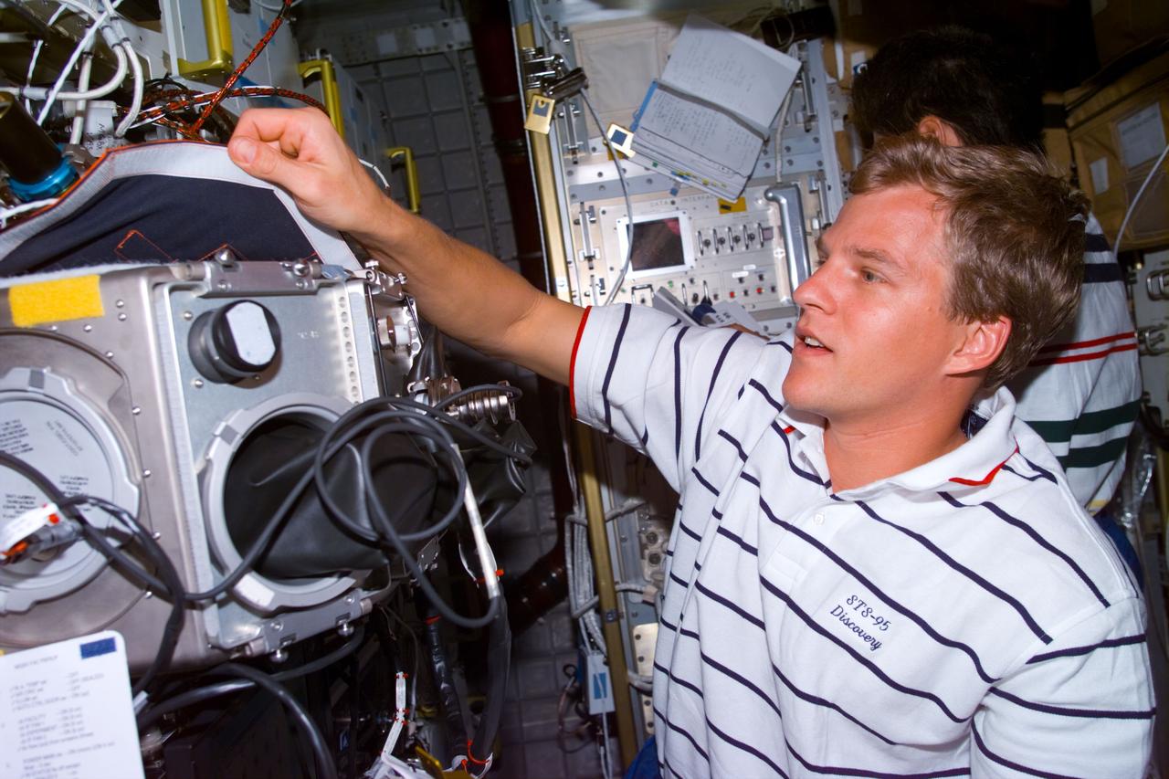STS095-E-5104 (2 Nov. 1998) --- Astronaut Scott E. Parazynski, STS-95 mission specialist, at glove box in Spacehab facility during flight day four activity. The photo was taken with an electronic still camera (ESC) at 4:59:22 GMT, Nov. 2.