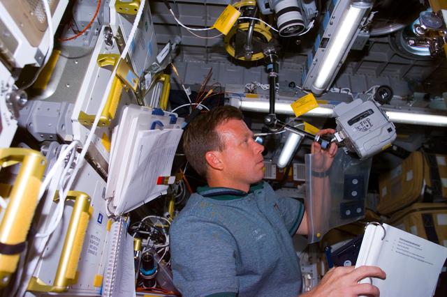 NASA image: Lindsey sets up a camera to record and experiment in the Spacehab module