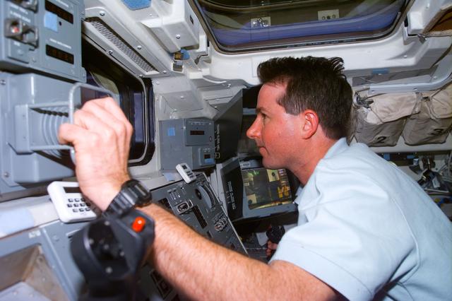 NASA image: Robinson at RMS control on flight deck during SPARTAN capture