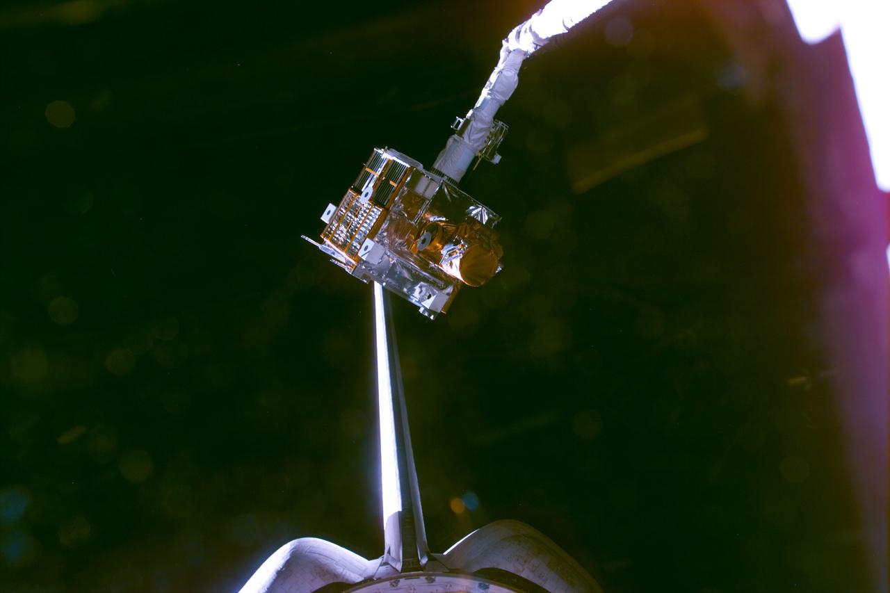 STS095-E-5139 (3 Nov. 1998) --- In the grasp of Discovery's remote manipulator system (RMS) arm, the Spartan 201-05 satellite hovers over the cargo bay prior to its berthing there.  The photo was taken with an electronic still camera (ESC) at 03:59:12 GMT, Nov. 3.