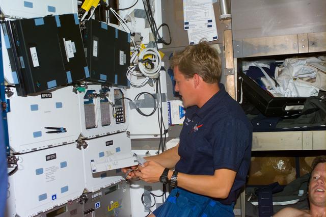 NASA image: Parazynski reviews a checklist on the middeck