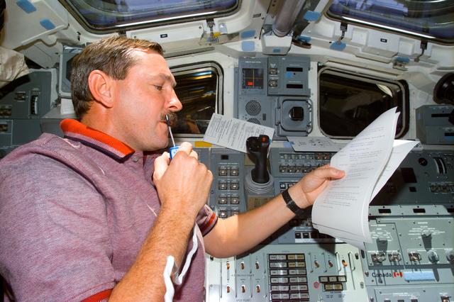 NASA image: Brown on aft flight deck with microphone
