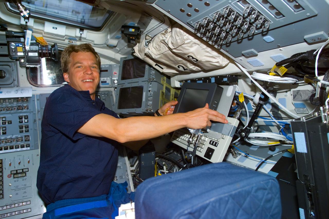 STS095-E-5181 (31 Oct. 1998) --- Astronaut Scott E. Parazynski, STS-95 mission specialist, pictured at a lap top computer on the flight deck of Space Shuttle Discovery. The photo was taken with an electronic still camera (ESC) at 02:05:37, Oct. 31.