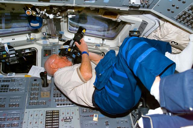 NASA image: Glenn at aft flight deck window with camera