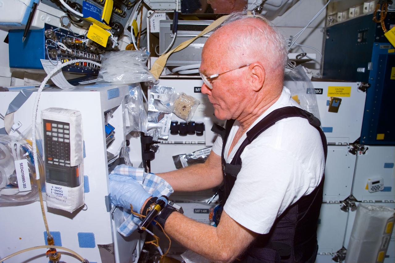 STS095-E-5206 (4 Nov. 1998) --- U.S. Sen. John H. Glenn Jr., STS-95 payload specialist, keeps up his busy test agenda during Flight Day 7 onboard Discovery. The photo was taken with an electronic still  camera (ESC) at 19:05:17 GMT, Nov. 4.
