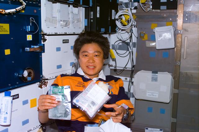 Mukai on middeck with food packets
