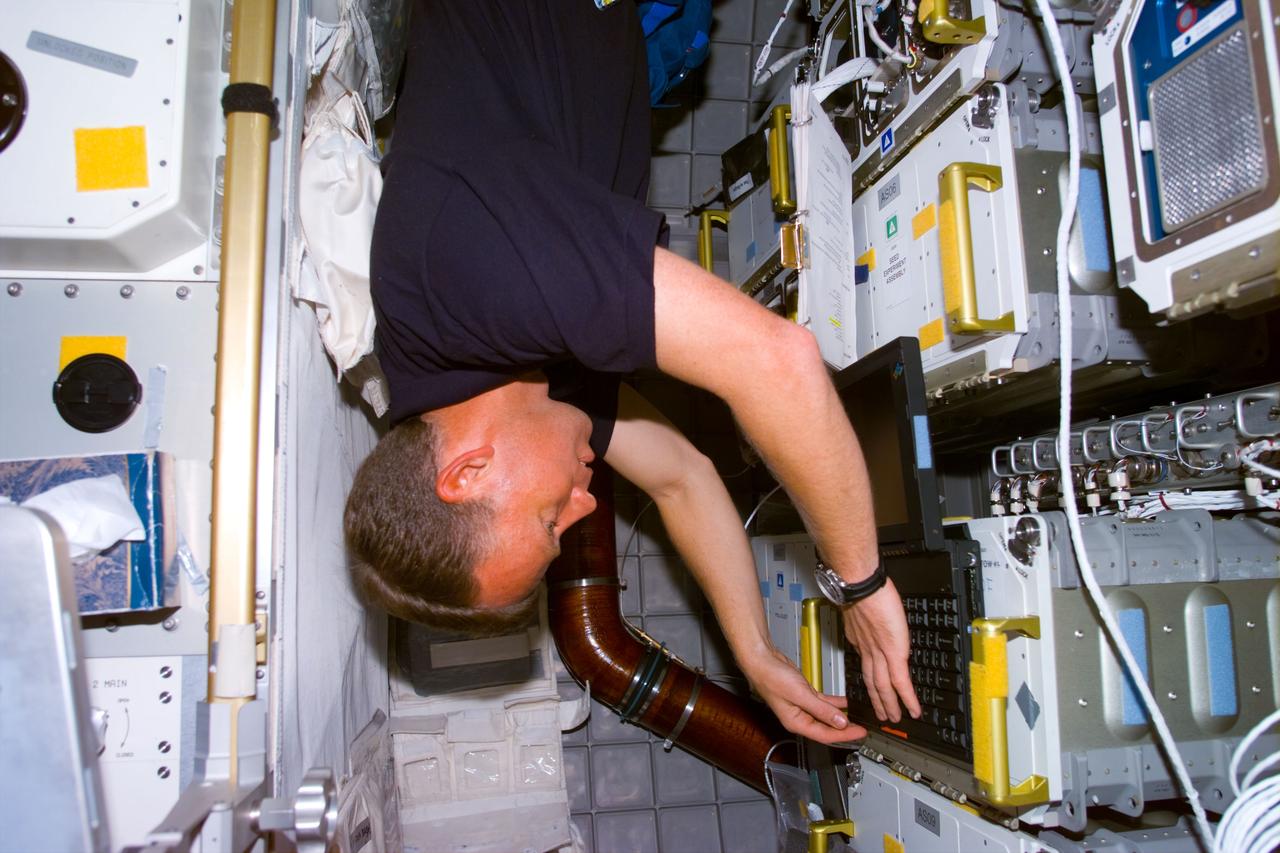 STS095-E-5218 (4 Nov. 1998) --- Astronaut Steven W. Lindsey, STS-95 pilot, inputs data on a lap top computer in the Spacehab facility onboard the Space Shuttle Discovery.  The photo was taken with an  electronic still camera (ESC) at 02:58:43 GMT, Nov. 4.