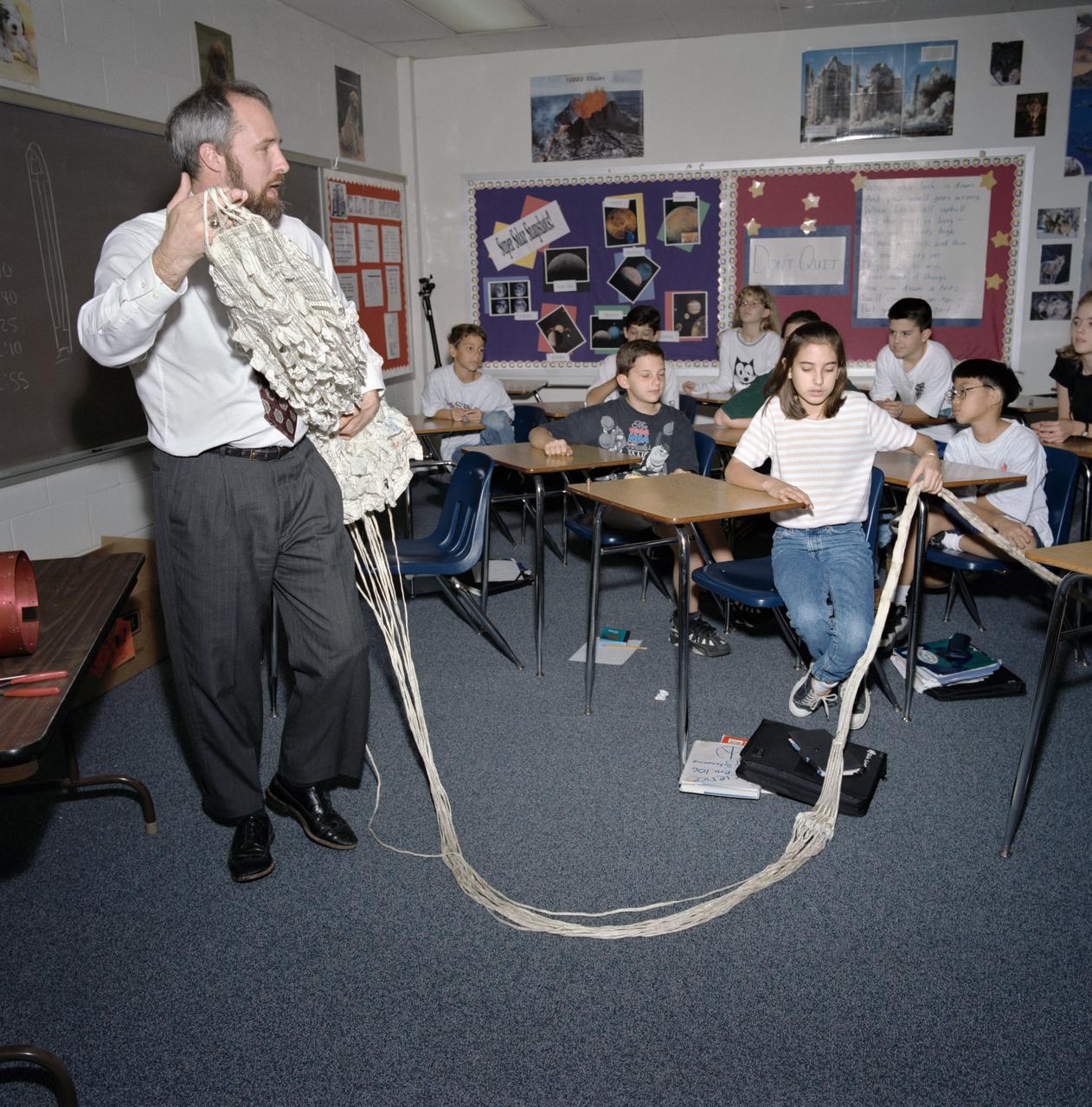 Johnson Space Center (JSC) engineer visits Clear Lake Intermediate School during National Engineers Week February 1996. Demonstrating a parachute to the students is Keith E. Van Tassel.