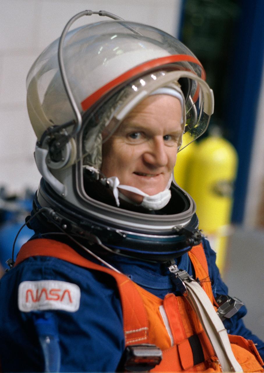 S96-08067 (April 1996) --- Astronaut John H. Casper, mission commander, has finished the final touches of suit donning and awaits the beginning of a training session for emergency bailout.  All six crew members participated in the session, held in the Johnson Space Center?s (JSC) Weightless Environment Training Facility (WET-F).  The six astronauts will spend nine days aboard the Space Shuttle Endeavour next month.