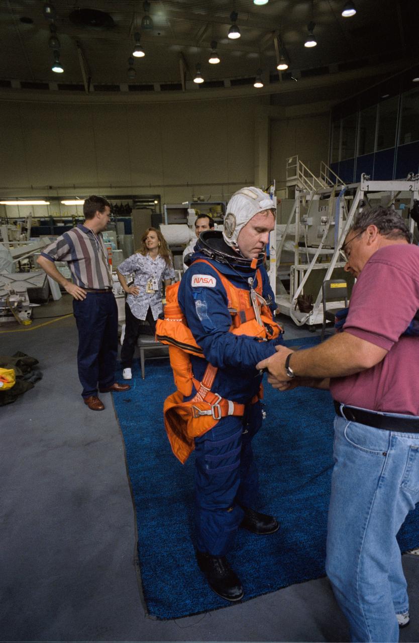 S96-08072 (April 1996) --- Astronaut Andrew S. W. Thomas, mission specialist, is helped with the final touches of suit donning during emergency bailout training for crew members in the Johnson Space Center?s (JSC) Weightless Environment Training Facility (WET-F).  Thomas will join five other astronauts for nine days aboard the Space Shuttle Endeavour next month.