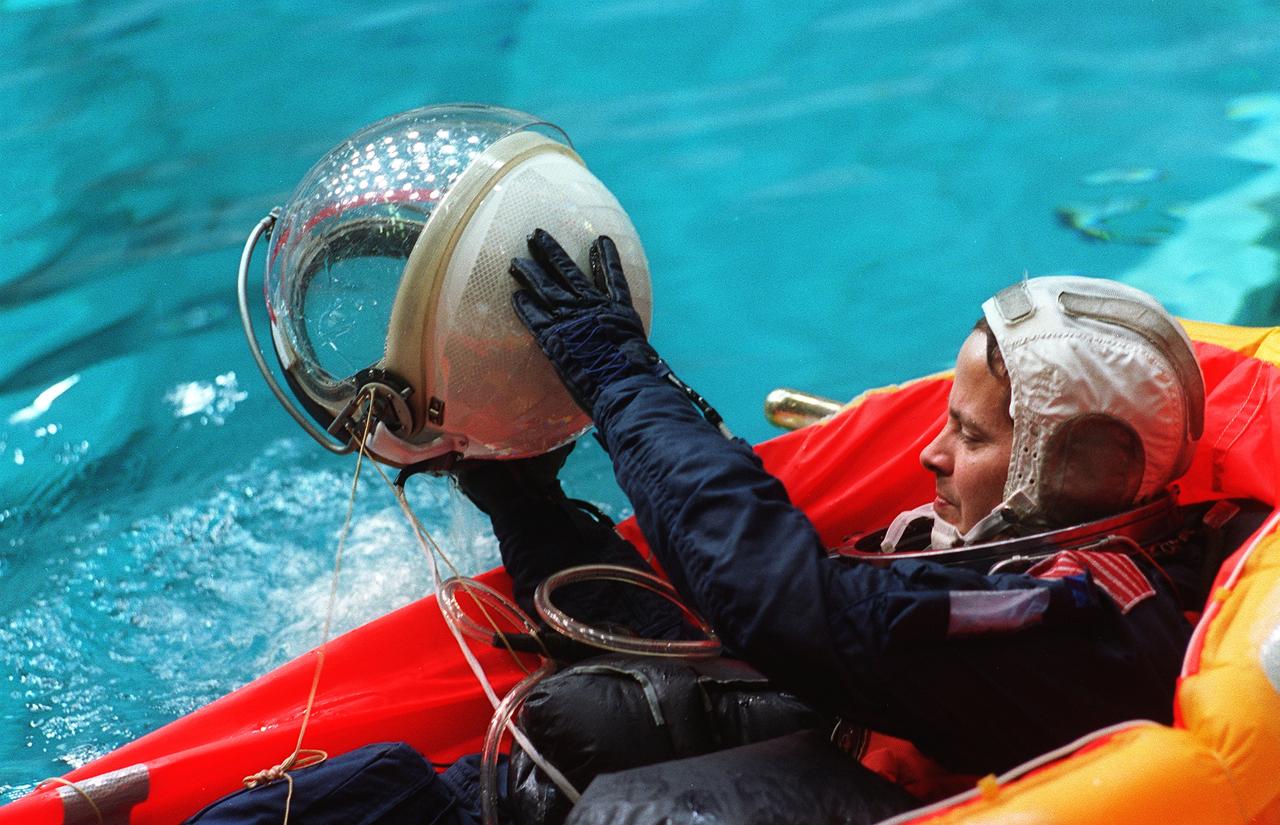 S96-08073 (April 1996) --- Astronaut Daniel W. Bursch, mission specialist, uses his helmet to bail out water from his life raft during emergency bailout training for crewmembers in the Johnson Space Center's (JSC) Weightless Environment Training Facility (WET-F). Bursch will join five other astronauts for nine days aboard the Space Shuttle Endeavour next month.