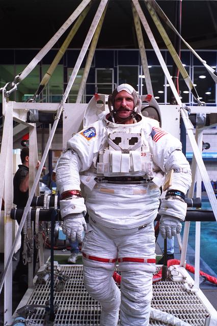 NASA image: Astronauts Greg Harbaugh and Joe Tanner suit up for training in WETF