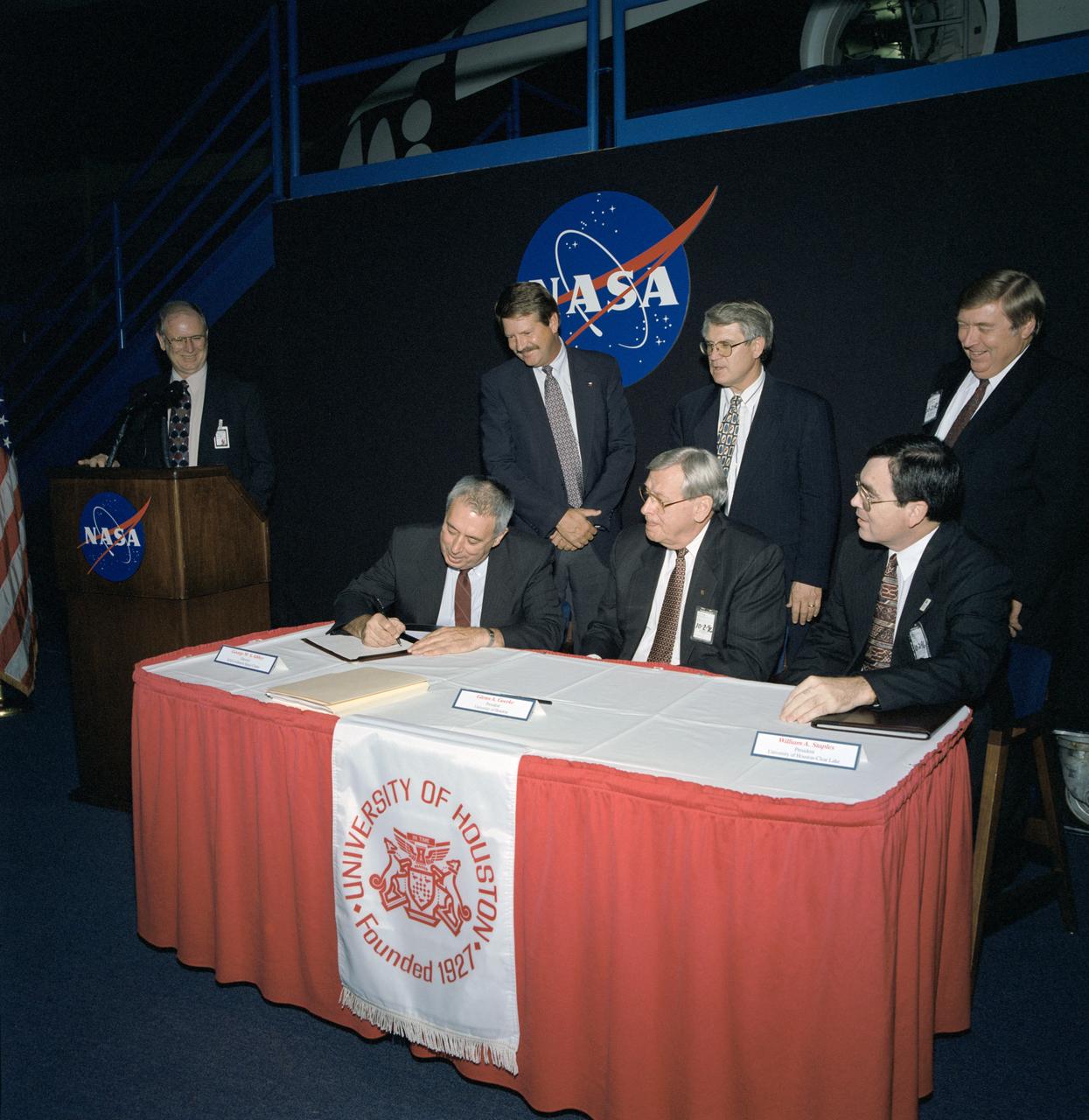 NASA/University of Houston (UH) signing of memorandum of understanding. Johnson Space Center (JSC) Director George Abbey signs a memorandum of understanding with University of Houston's President Glenn Goerke and University of Houston Clear Lake President Williams Staples. UH will supply post-doctoral researchers to JSC for more than 15 projects of scientific interest to both JSC and the university. Seated from left are, Abbey, Goerke and Staples. Standing from left are David Criswell, director of the Institute of Space Systems Operations; Texas State Representatives Michael Jackson, Robert Talton and Talmadge Heflin. View appears in Space News Roundup v35 n41 p4, 10-18-96.