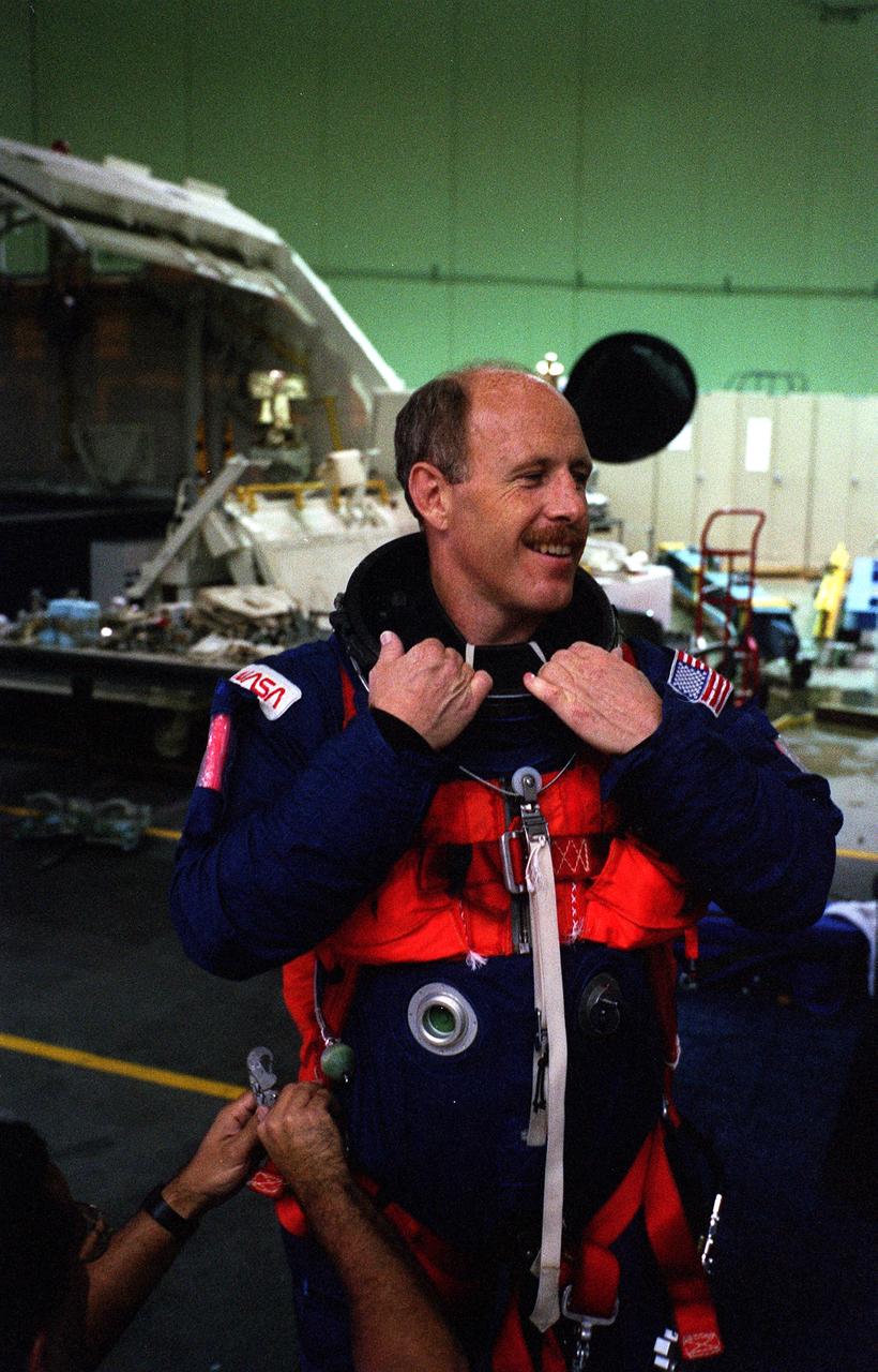S96-18547 (30 Oct. 1996) --- Astronaut Kenneth D. Bowersox, STS-82 mission commander, chats with a crewmate (out of frame) prior to an emergency bailout training session in JSC's systems integration facility.  Wearing training versions of the partial pressure launch and entry escape suit, Bowersox and his crew simulated an emergency ejection, using the escape pole system on the middeck.
