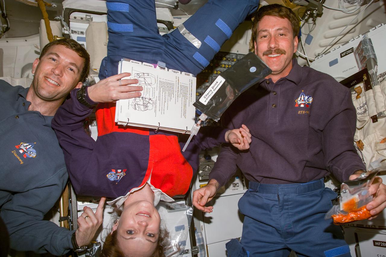 S96-E-5017 (29 May 1999) --- Three of Discovery's seven crew members are pictured during a break from activity on the mission's fourth day in space. From the left are Rick D. Husband, pilot; Tamara Jernigan, mission specialist, and Kent V. Rominger, commander. The photo was taken with an electronic still camera (ESC) at 09:50:34 GMT, May 29, 1999.