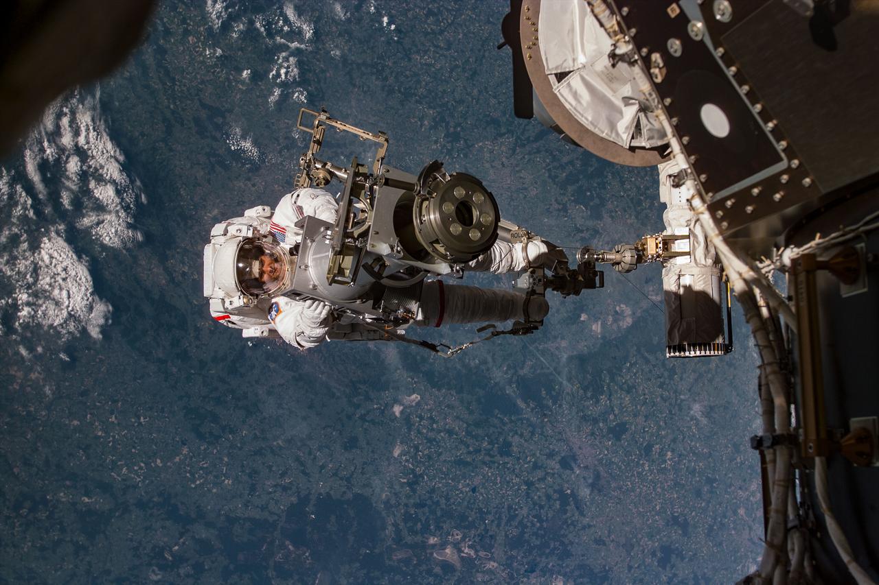 S96-E-5020 (30 May 1999) --- Astronaut Tamara Jernigan, backdropped against terrain, totes part of a Russian-built crane, called Strela (a Russian word meaning "arrow"). Jernigan's feet are anchored on a mobile foot restraint connected to Discovery's remote manipulator sytsem (RMS).  Astronauts Jernigan and Daniel T. Barry went on to spend over seven hours on the space walk.  The photo was recorded with an electronic still camera (ESC) at 06:36:22 GMT, May 30, 1999.