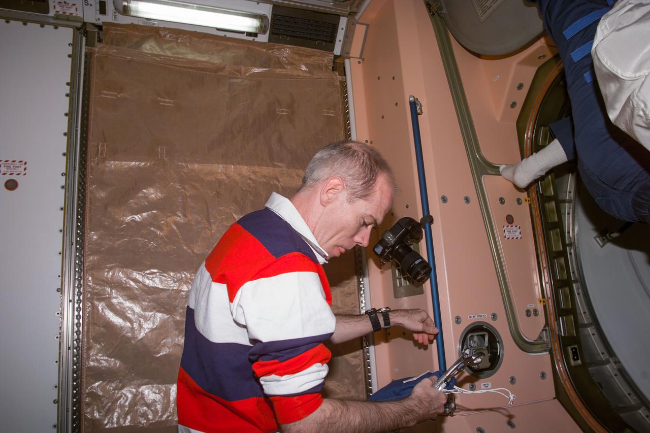 S96-E-5080 (31 May 1999) --- Astronaut Daniel T. Barry, mission specialist, participates in the Flight Day 5 team effort to ready International Space Station (ISS) hardware. After ingressing the Pressurized Mating Adapter (PMA2), Barry and fellow crew members went into the Unity node to perform a variety of chores.  The scene was recorded with an electronic still camera (ESC) at 01:54:41 GMT, May 31, 1999.