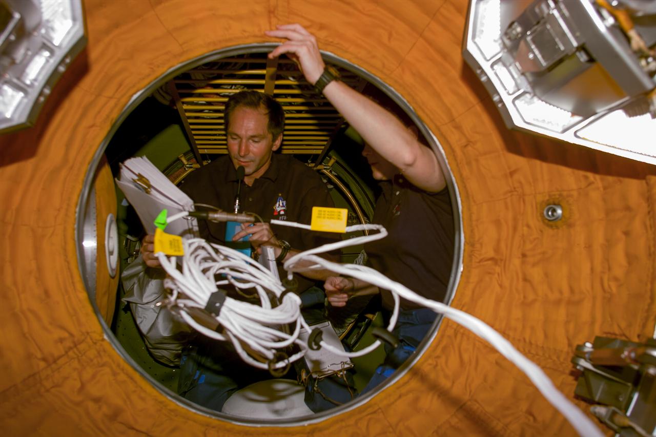 S96-E-5084 (31 May 1999) --- Cosmonaut Valery I. Tokarev and astronaut Tamara Jernigan are almost obscured by communications gear in this   scene recorded in the passageway to the Russian-built Zarya module.  Tokarev is a mission specialist representing the Russian Space Agency (RSA).  Jernigan is one of two mission specialists that earlier had performed a lengthy space walk to do some exterior work on the International Space Station (ISS). The scene was recorded with an electronic   still camera (ESC) at 02:09:00 GMT, May 31, 1999.