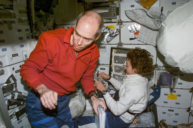 NASA image: Daniel Barry and Ellen Ochoa on middeck with food