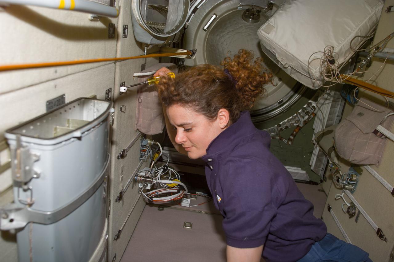 S96-E-5122 (1 June 1999) --- Astronaut Julie Payette uses a conventional screw driver while performing a Flight Day 6 task in the Russian-built Zarya module.  The photo was recorded with an electronic still camera (ESC) at 07:47:47 GMT, June 1, 1999.