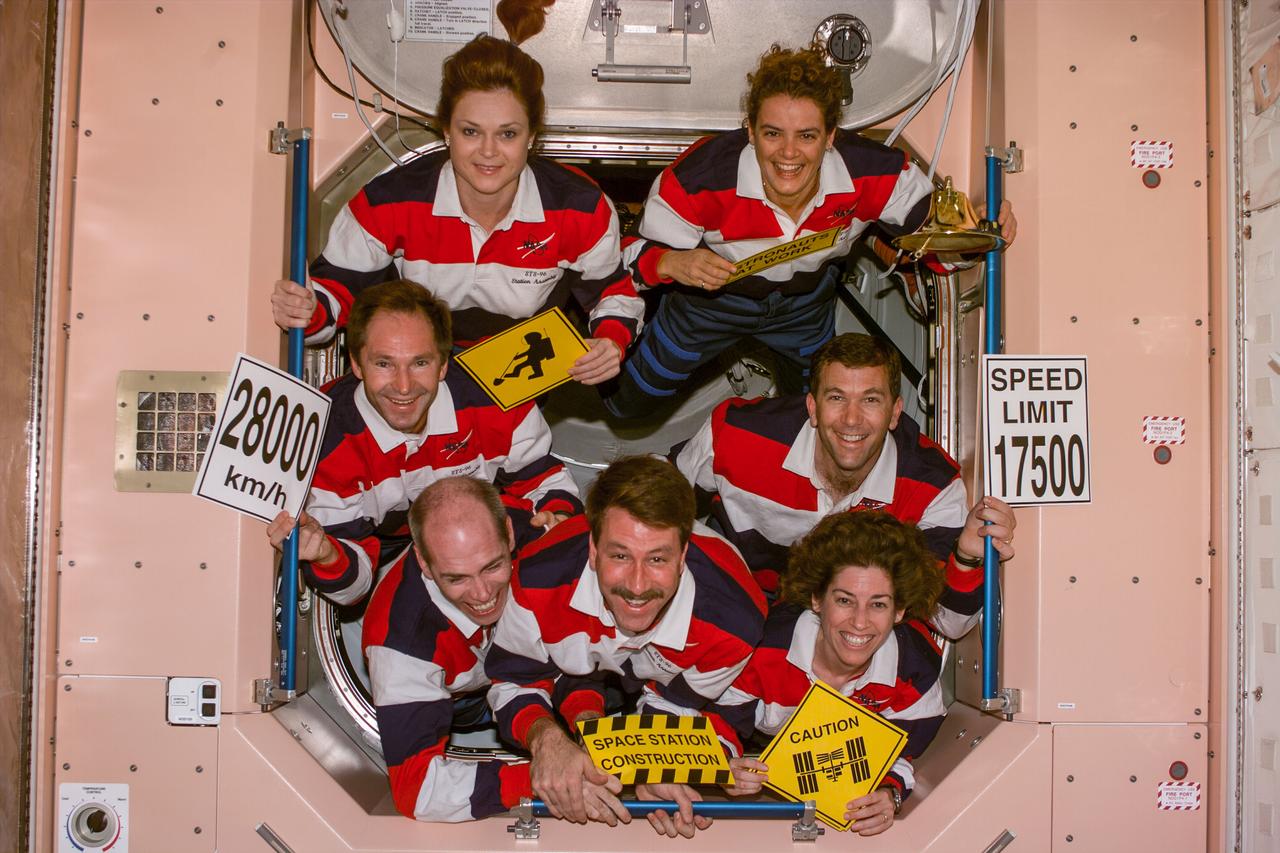 S96-E-5168 (02 June 1999) --- The  seven crew members for STS-96 pose for  an inflight crew portrait at the completion of their assigned chores on the International Space Station (ISS).  At bottom center is  astronaut Kent V. Rominger, mission commander.  He is flanked by astronauts Daniel T. Barry   and Ellen Ochoa, mission specialists.  Also pictured are cosmonaut Valery I.  Tokaerev (just above Barry at left);  and astronauts Tamara Jernigan and Julie Payette, all mission specialists.  Astronaut Rick D. Husband, pilot, is  between Payette and Ochoa. Tokarev represents the Russian Space Agency (RSA) and Payette is with the Canadian Space Agency (CSA).  The photograph was taken with an electronic still camera (ESC) at 11:02:32 GMT,  June 2, 1999.