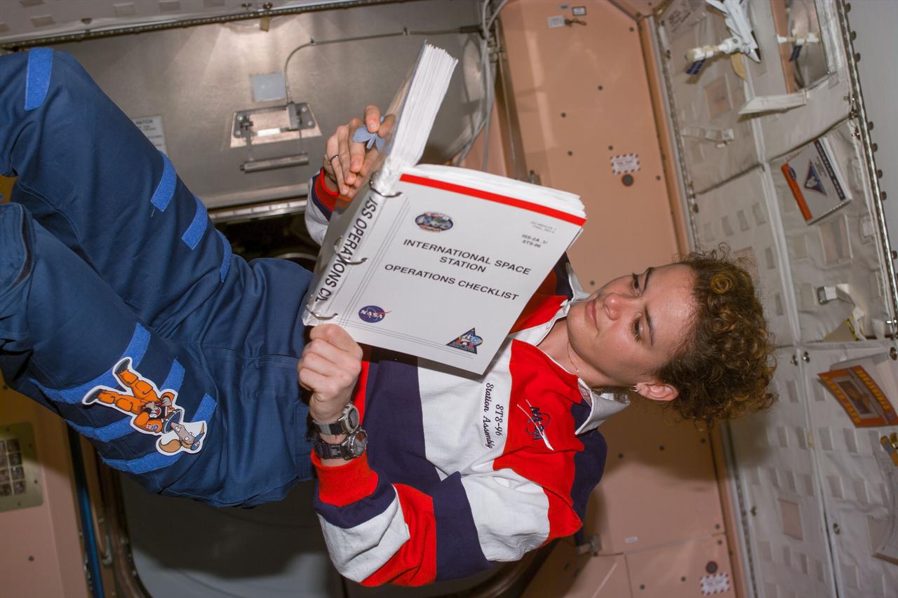 S96-E-5179 (2 June 1999) --- Astronaut Julie Payette, mission specialist representing the Canadian Space Agency (CSA) looks over the  operations checklist for International   Space Station (ISS) while performing final STS-96 tasks aboard it.  The photo was taken with an electronic still camera (ESC) at 12:11:14 GMT, June 2, 1999.