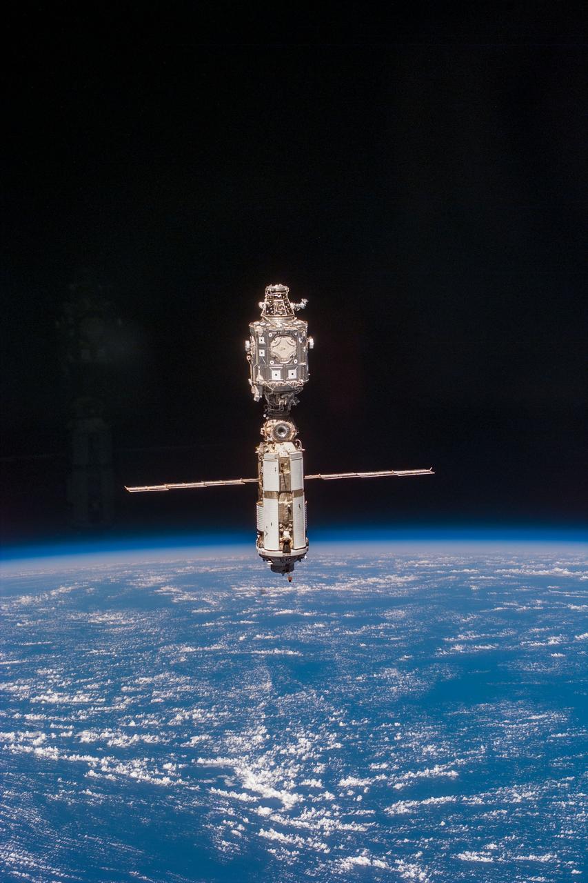 S96-E-5219 (03 June 1999) --- The International Space Station (ISS) is backdropped against the blue and white   horizon scene of Earth and the blackness of space following separation from Discovery.  The photograph was taken with an electronic still camera (ESC) on Discovery's aft flight deck at 23:11:05 GMT, June 3, 1999.