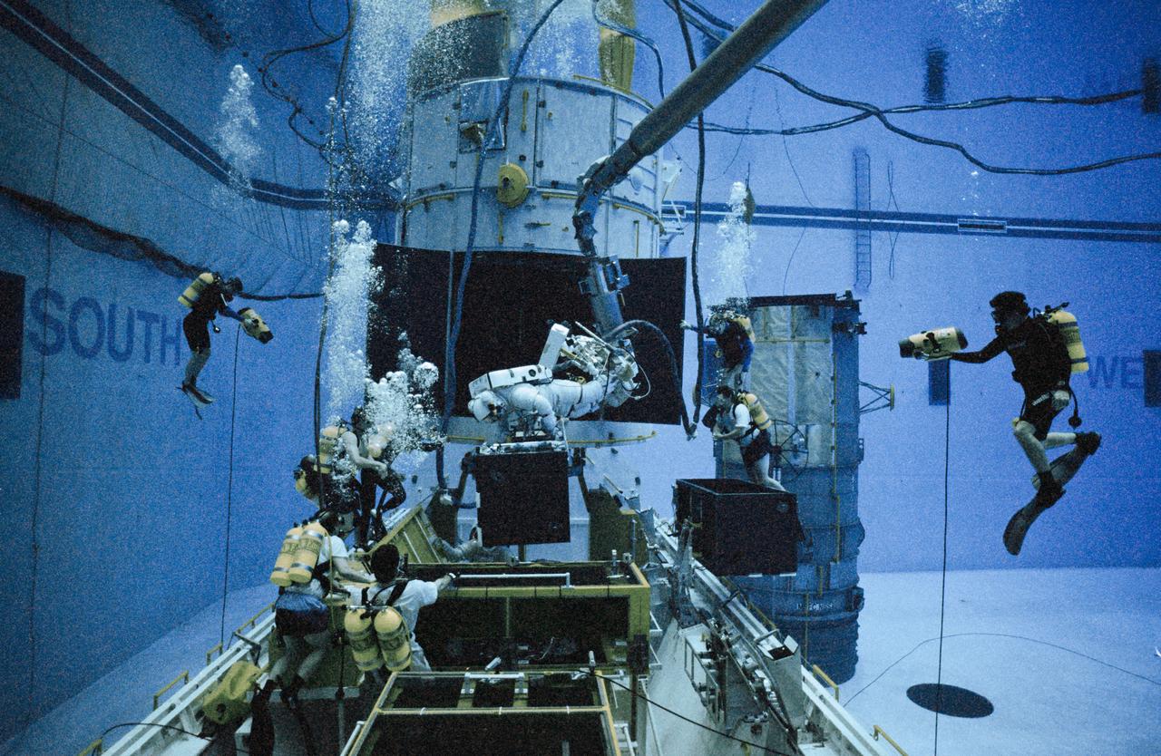 S97-00573 (8 Jan 1997) --- In the new Neutral Buoyancy Laboratory (NBL) at the Sonny Carter Training Center Facility, one of the STS-82 astronauts and an instructor practice procedures to be used during four scheduled space walks to service the Hubble Space Telescope (HST).  At present, four sessions of Extravehicular Activity (EVA), are planned, using two pairs of astronauts on alternating days.  Mark C. Lee, payload commander, will work with Steven L. Smith, while Gregory J. Harbaugh will team with Joseph R. Tanner.  Astronaut Jeffrey A. Hoffman, who performed three EVA?s on the initial HST-servicing mission, helped to train the astronauts.