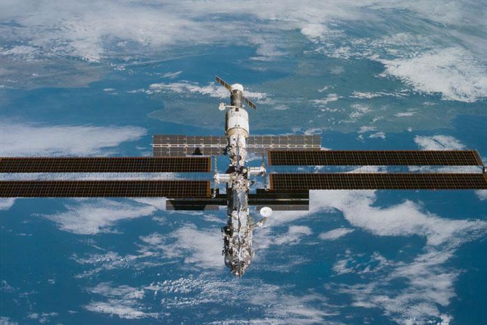 View of the International Space Station (ISS) over a cloudy Earth following undocking at 1:13 p.m.  (CST),December 9,2000 during the STS-97 flight.